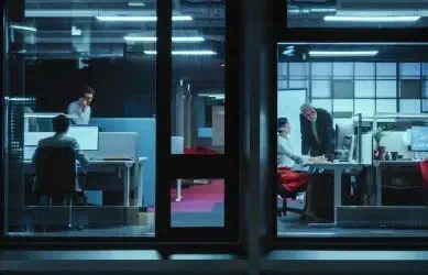 An office with harsh light two people working